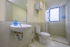 A bathroom with a sink, toilet, and shower. - Comfort and Strategic 3BR Meikarta Apartment (Cikarang)