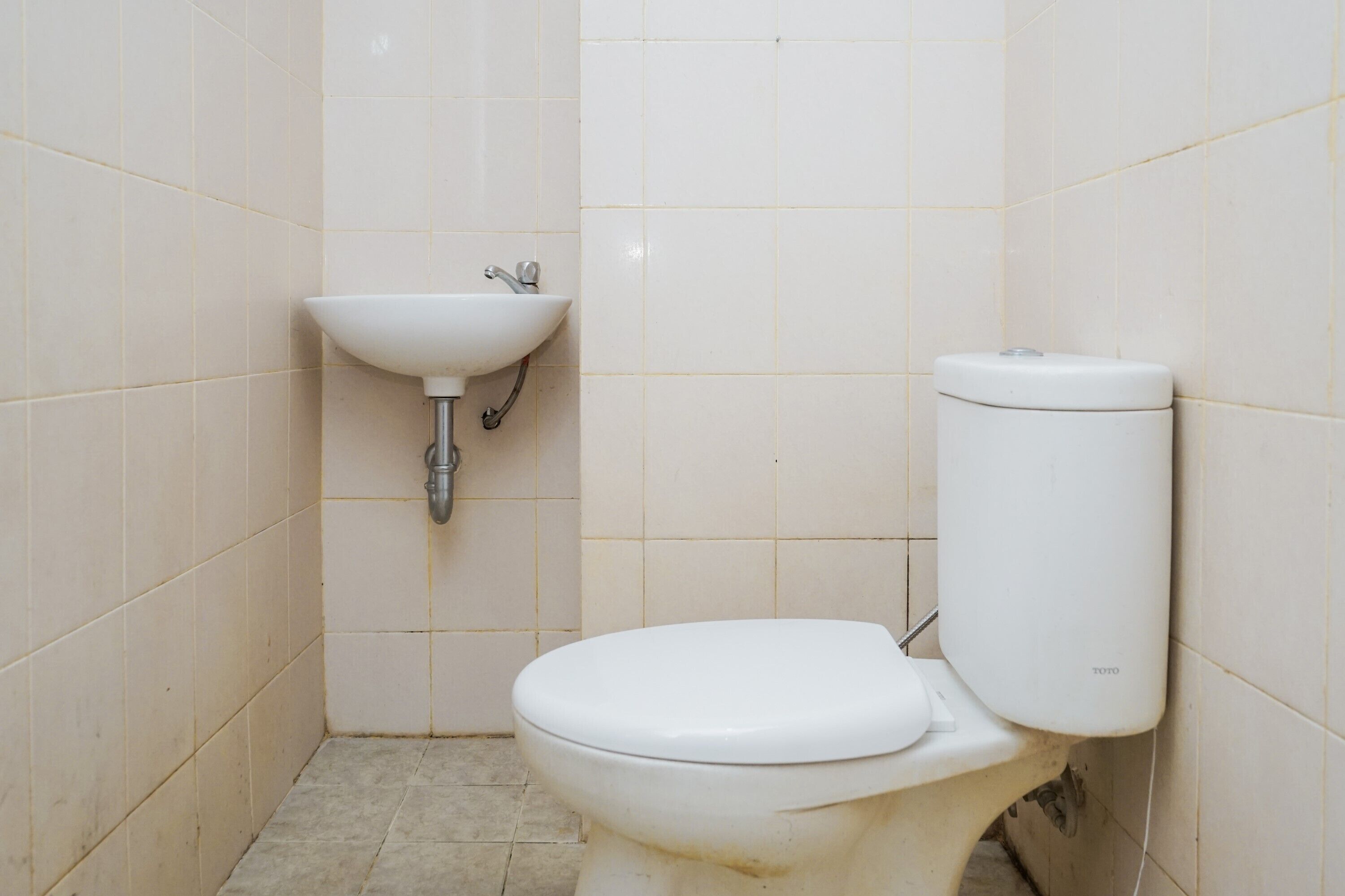 A small, clean bathroom with a white toilet and sink.