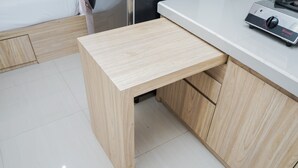 A kitchen with a wooden countertop, a sink, and a cabinet. - Fully Furnished with Cozy Design Studio Poris 88 Apartment (Tangerang)