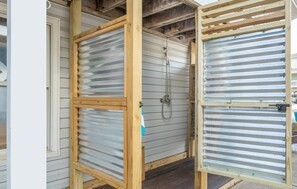 entrance with metal door and shower facility.