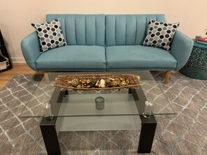 Relax in this inviting living room with a comfortable sofa, coffee table, and patterned rug.