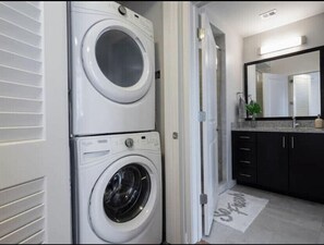 Convenient laundry facilities with two front-loading washing machines and a spacious layout.