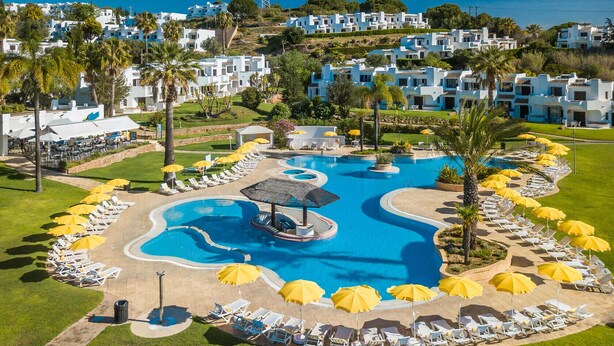 A resort with a large swimming pool, sun loungers, and a gazebo. - Clube Albufeira, Family Holidays with Pool View (Albufeira)