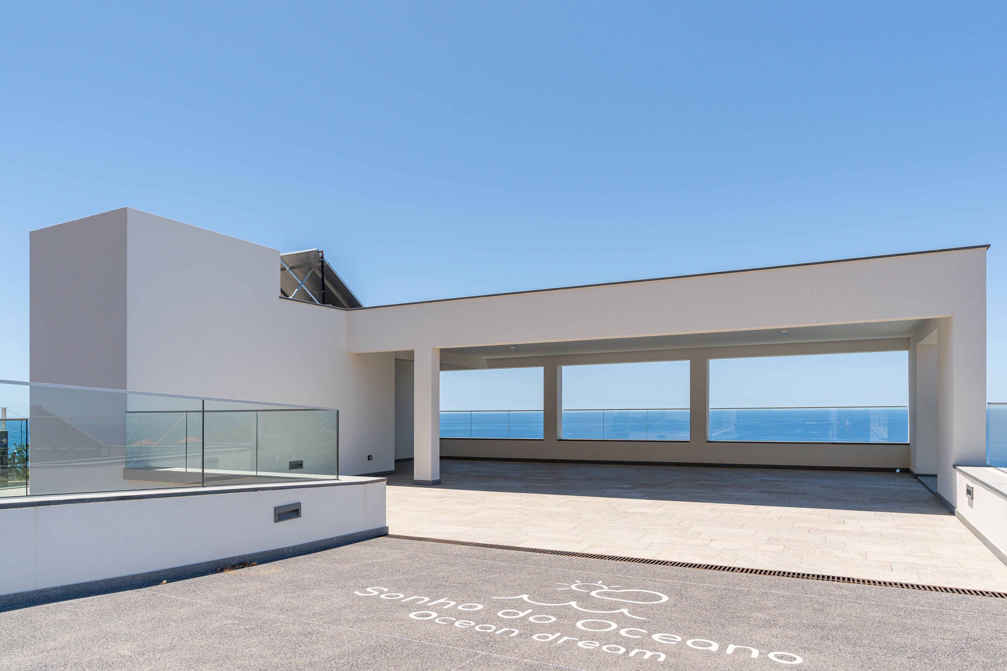 Ein modernes Gebäude mit großen Fenstern mit Blick auf den Ozean.