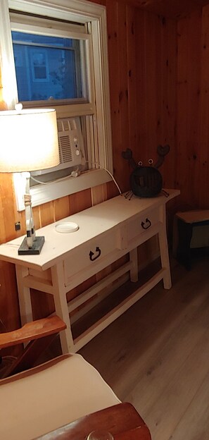 Cozy room with a desk, chair, and window offering a view of the outside.