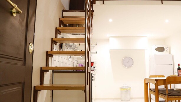 A staircase with wooden steps and metal railings leading to a second floor. - Casa Opera lovely apartment in Rome (Roma)