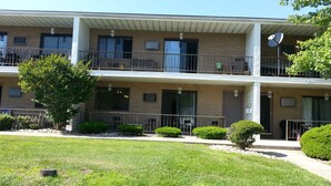 A two-story building with a flat roof, multiple balconies, and a satellite dish. - Summer Rental - Great Location - West End Section of Long Branch - Walk to beach (Long Branch)