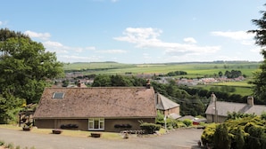 A rural house with a tiled roof, surrounded by greenery and fields. - Rose Bank (Belford)