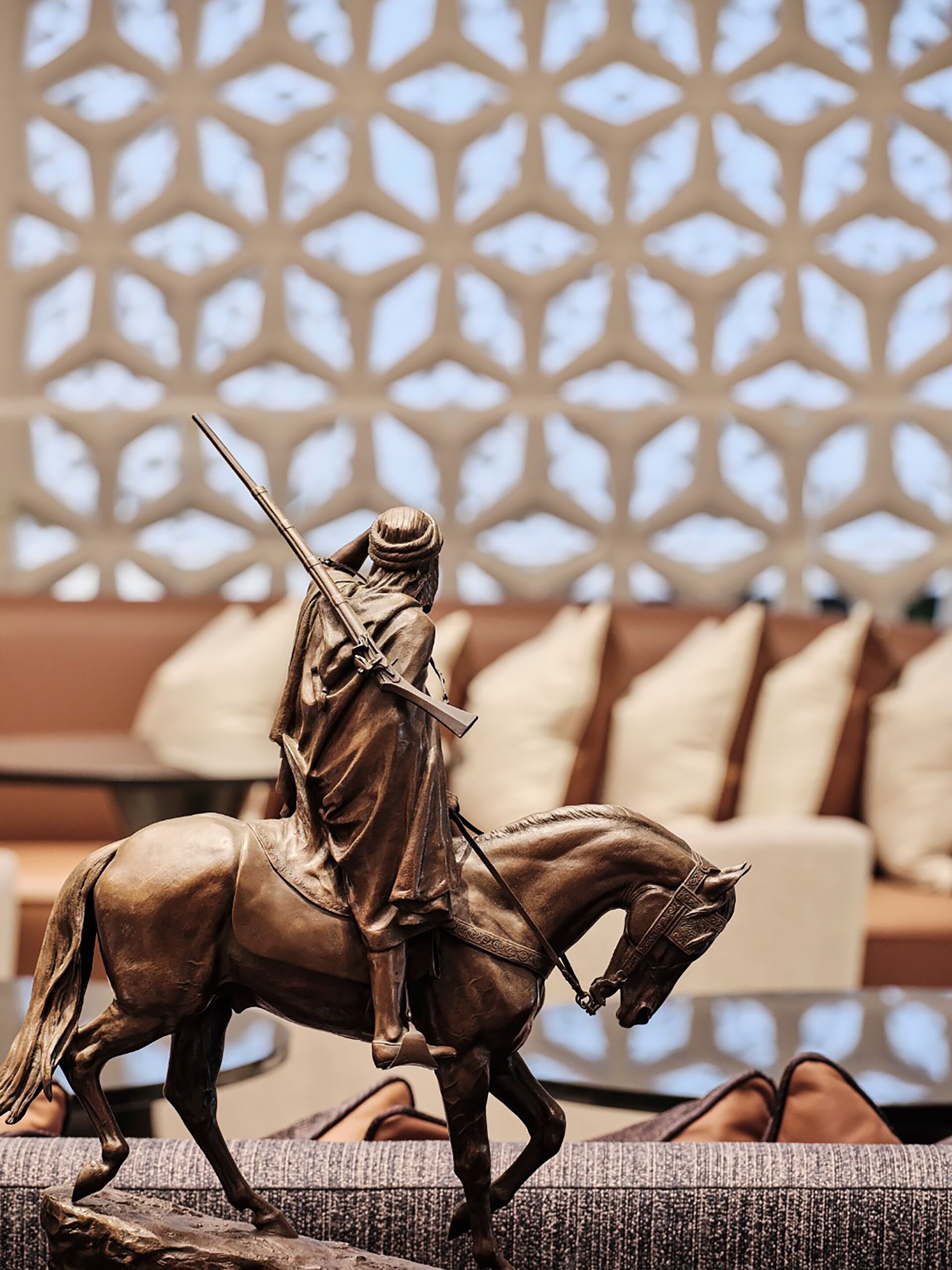 A statue of a rider on horseback in a modern interior setting.