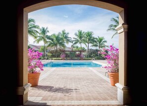 Step into a tranquil oasis, surrounded by lush greenery and a serene swimming pool.