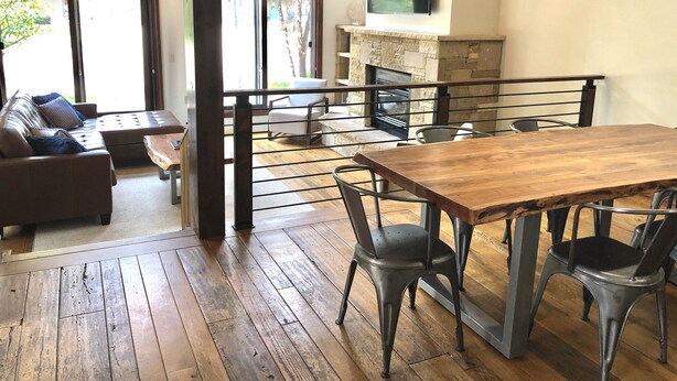 A spacious living area with a wooden dining table, metal chairs, a sofa with cushions, and a stone fireplace. - Pet-friendly 5 bed/4 bath home, just minutes to Beaver Creek, Avon, and Vail (Avon)