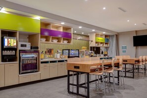 Enjoy meals and snacks in this well-appointed dining area, featuring a refrigerator and microwave for your convenience.