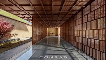 Stylish corridor leading to a reception area with a desk and chair.