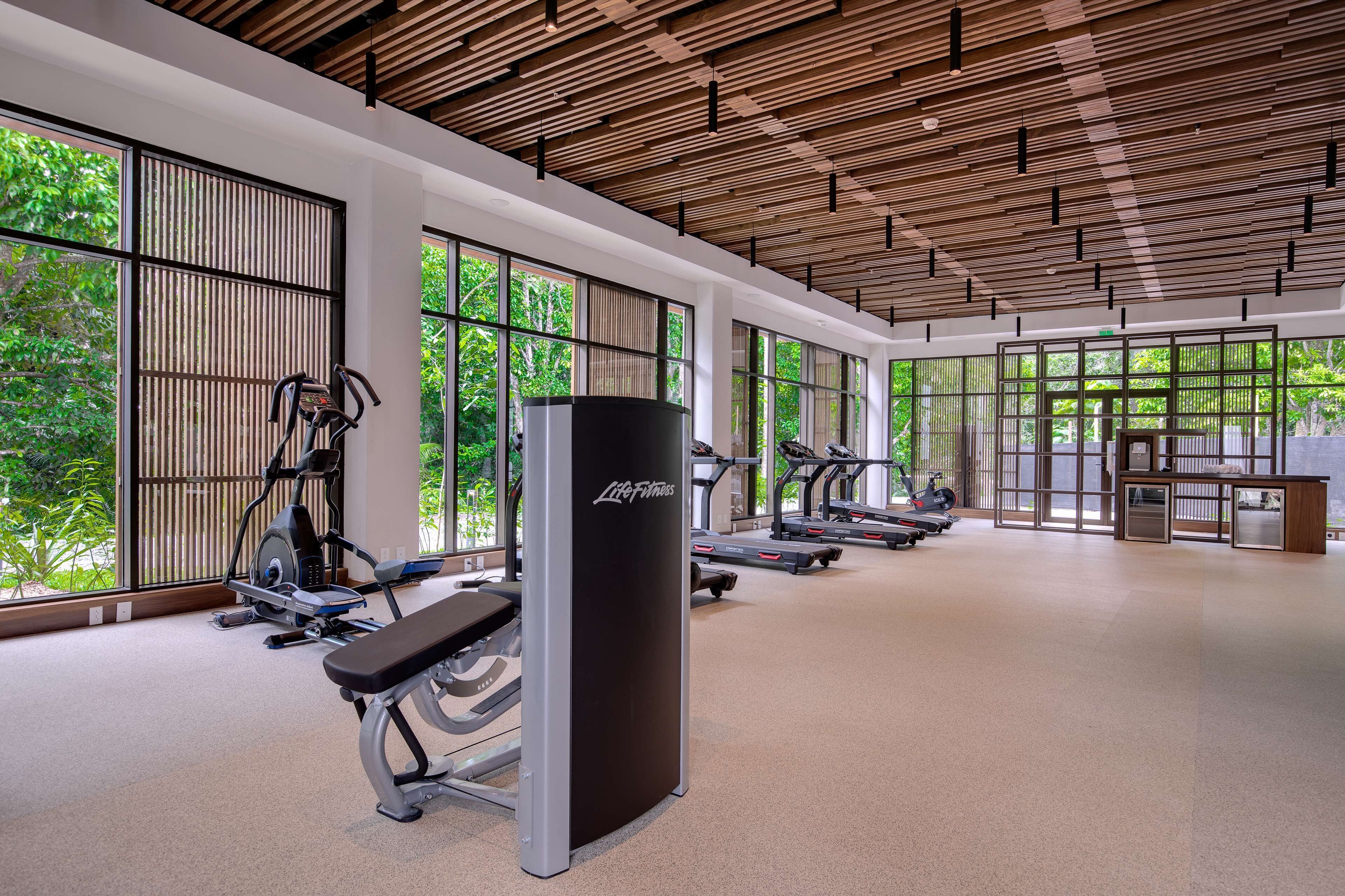 Ein modernes Fitnessstudio mit Laufbändern, Kraftstationen und einem Life Fitness Schlagbeutel.