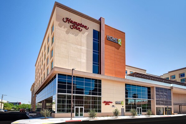 A Hampton Inn hotel with a modern facade, large glass windows, and a prominent 'HOME2' sign.