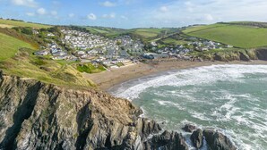 A coastal town with houses along the beach and cliffs in the foreground. - Close To The Beach,Wi-Fi, Parking (Challaborough)
