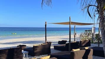 On the beach, white sand, sun-loungers