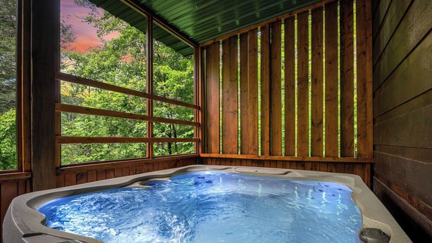 A hot tub with a wooden exterior and large windows.