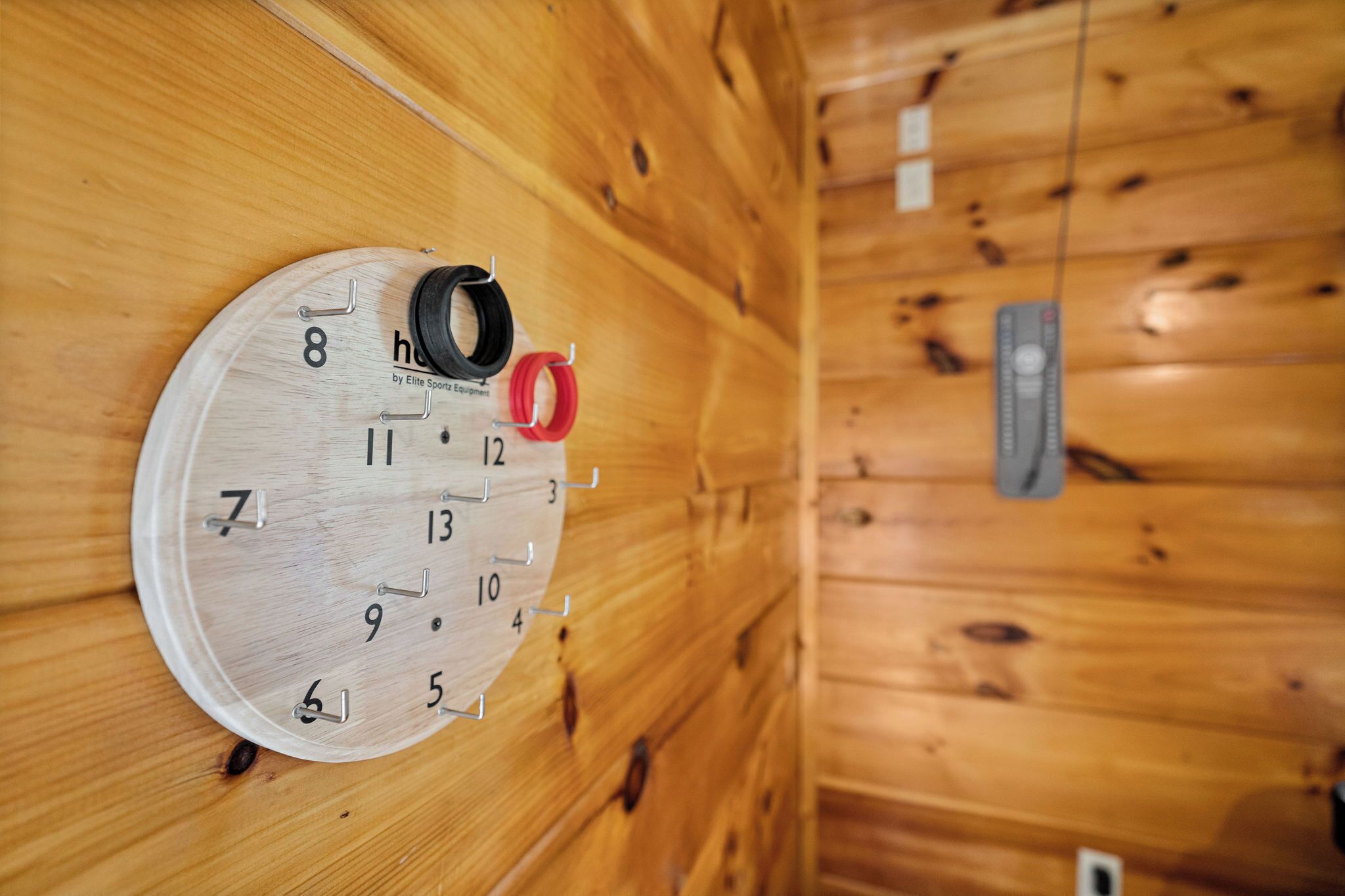 A wooden wall with a round clock displaying the time.