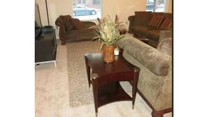 A living room with two couches, a coffee table, and a lamp. - Two bedroom apartment with lots of light (Atlanta)