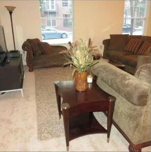 A living room with two couches, a coffee table, and a lamp. - Two bedroom apartment with lots of light (Atlanta)