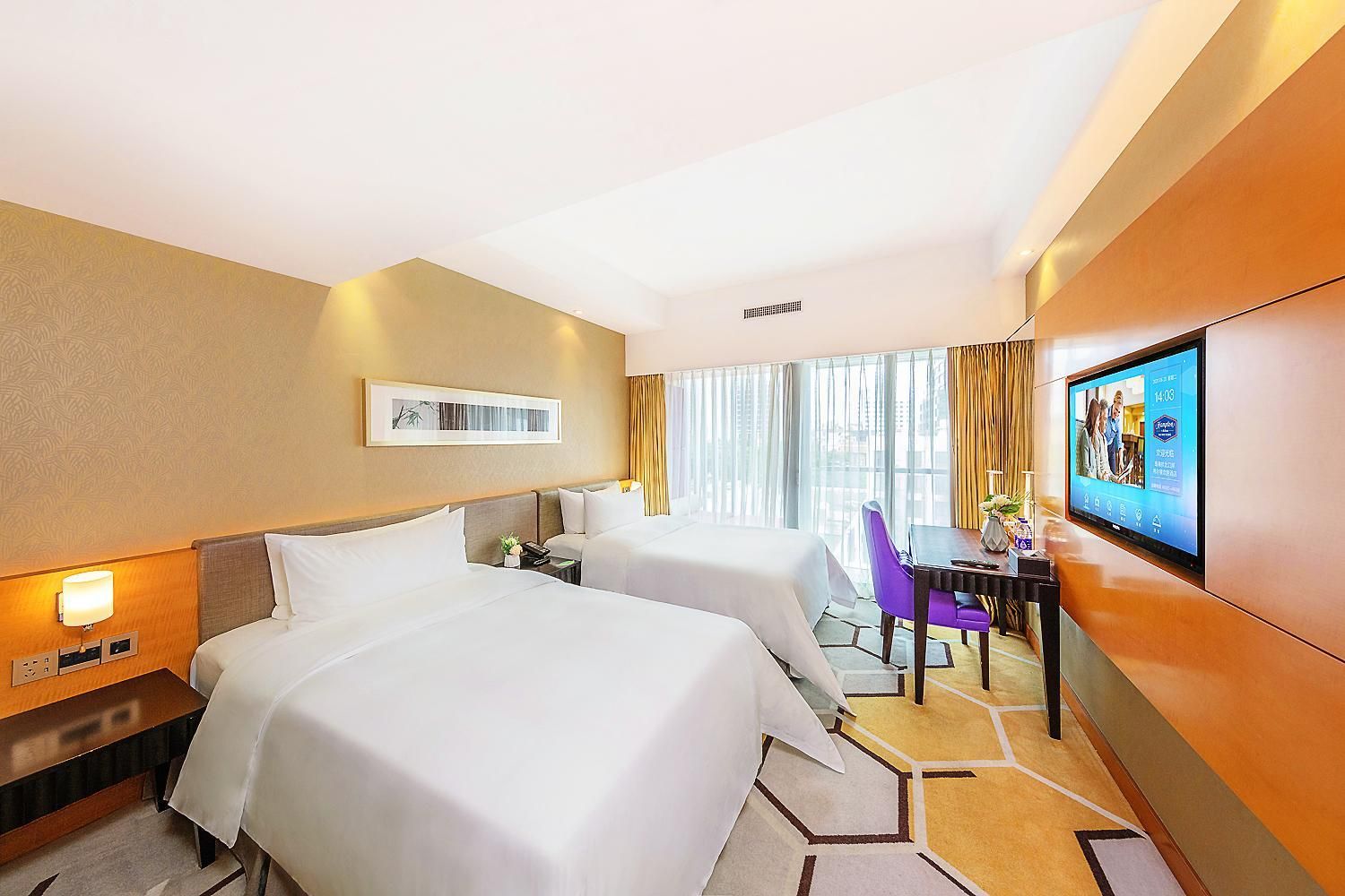 A hotel room with two beds, a desk with a chair, a TV, and a window with curtains.