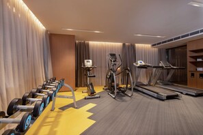 A hotel gym with exercise equipment including dumbbells, an elliptical, and treadmills. - Hampton BY Hilton Chengdu Wciec (CHENGDU)