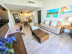 Relax in a spacious living area with a comfortable sofa and dining table.