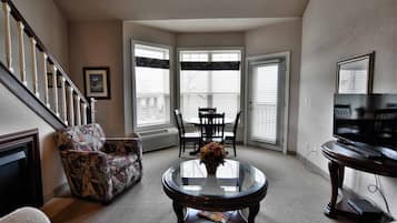 Condo, Multiple Beds, Balcony | Living room | 32-inch TV with cable channels, fireplace, MP3 dock
