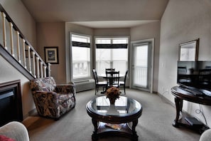 Condo, Multiple Beds, Balcony | Living room | 32-inch TV with cable channels, fireplace, MP3 dock