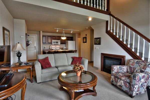 Condo, Multiple Beds, Balcony | Living room | 32-inch TV with cable channels, fireplace, MP3 dock