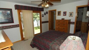 A bedroom with a bed, dresser, and a ceiling fan. - Seidls (Cable)