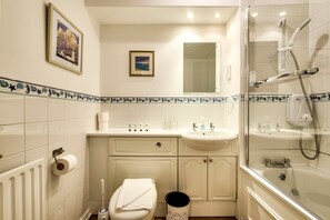 A compact bathroom with a toilet, sink, and shower. - GuestReady - 2BR in Leith w Ocean Views & Parking (Leith)