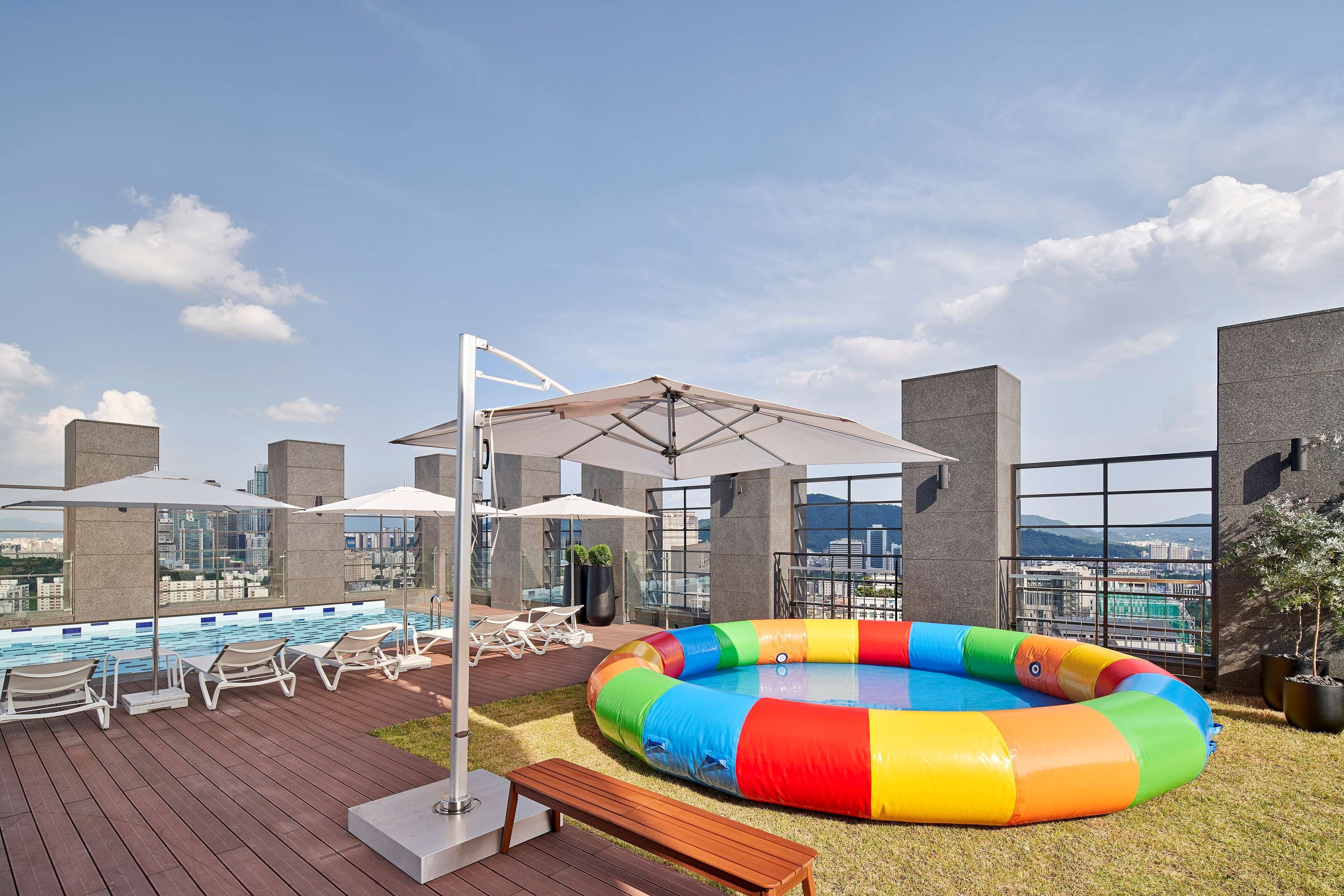 outdoor pool, pool loungers, lifeguards on site