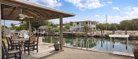 Relax, having a meal or get together under this amazing canal front tiki area.
