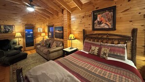 A cozy log cabin bedroom with a wooden ceiling, a bed with plaid bedding, a wooden headboard, and a framed fox painting on the wall.