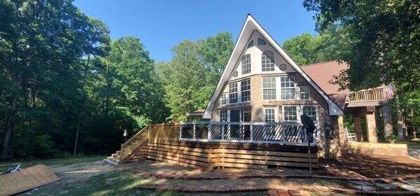 Enjoy the expansive views from the large windows and relax on the outdoor deck with a railing.