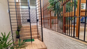 A staircase with a metal railing, leading to a higher floor. - Lar Recife Olinda - Casa Inteira (Recife)