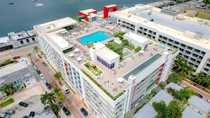 A modern hotel with a rooftop pool, multiple balconies, and a view of the water. - Hollywood Beach Haven - Rooftop Pool and Views-CS18 (Hollywood)