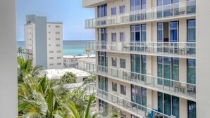 A multi-story hotel with balconies overlooking a beach. - Luxury Ocean Breeze Condo W/ Balcony at CH-CS22 (Hollywood)