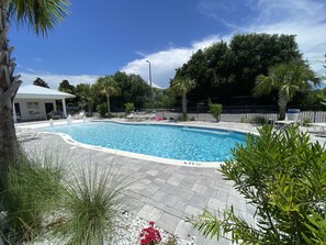A swimming pool with lounge chairs, surrounded by palm trees and a covered seating area. - Hidden Lake Condos on 30A, 6min walk to Gulfview Heights beach access, pool, gym (Santa Rosa Beach)