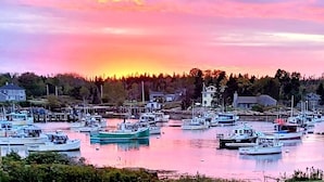 A marina with multiple boats docked, surrounded by residential buildings and trees. - Spectacular Corea Harbor side Home minutes to Acadia National Park Schoodic Gate (Gouldsboro)