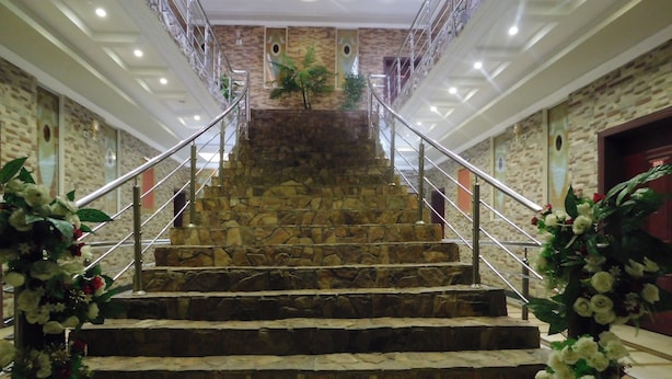 A stone staircase with metal railings, leading to an upper level. - Triple One Hotel Suites (Abbottabad)