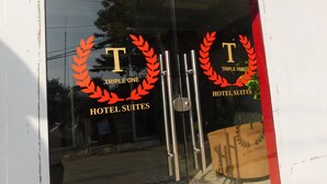 A hotel entrance with a glass door and a metal handle. - Triple One Hotel Suites (Abbottabad)