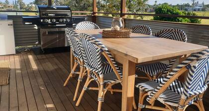 Indoor/outdoor pet-friendly beach house next to world-class beach and river.