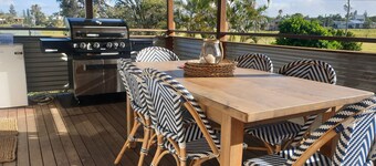 Indoor/outdoor pet-friendly beach house next to world-class beach and river.