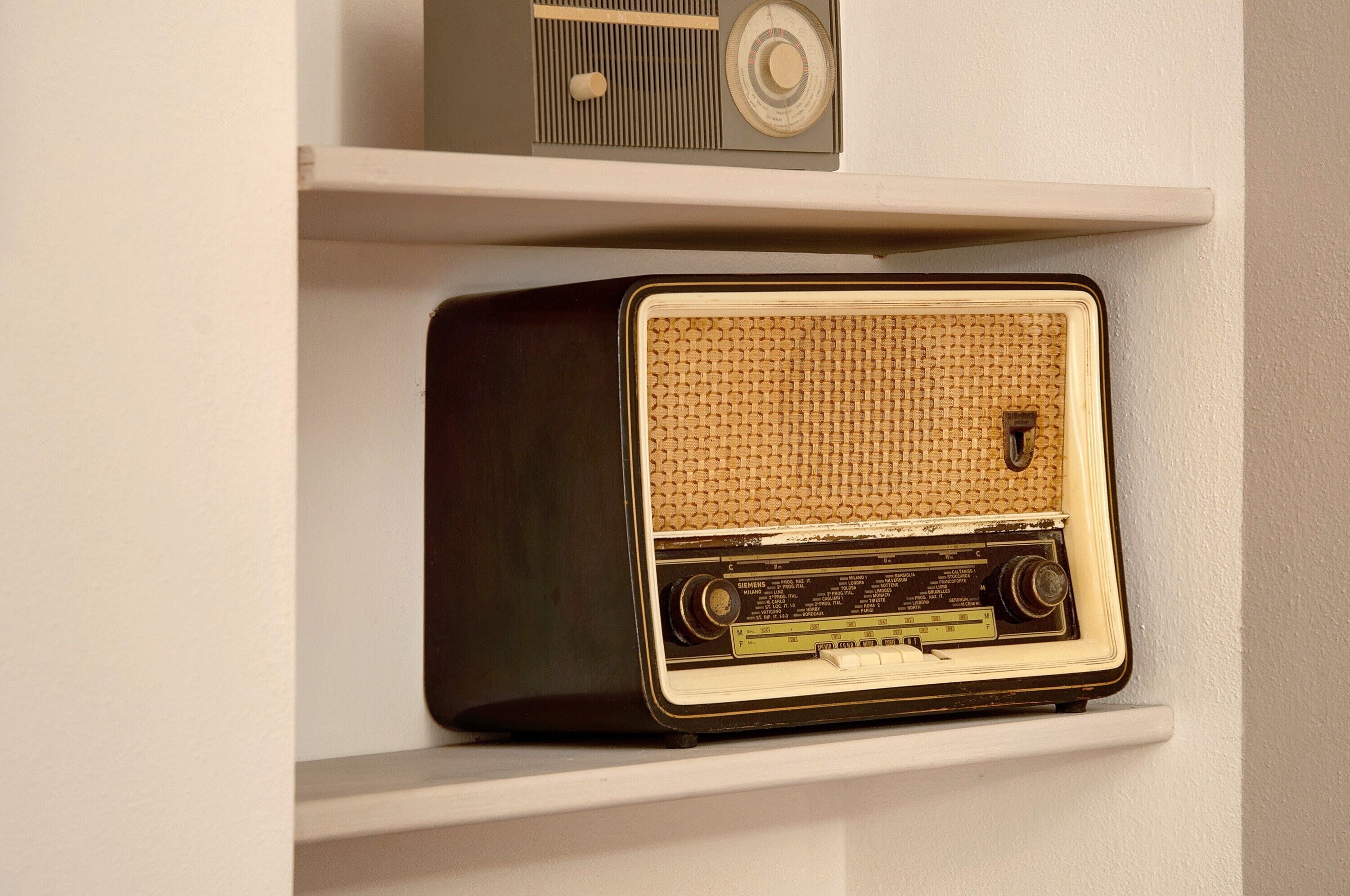 A vintage radio on a shelf.