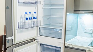 A modern kitchen with a built-in refrigerator, a microwave, and a stove. - TWO BEDROOM LUXURY GROUND FLOOR APARTMENT.  (London)
