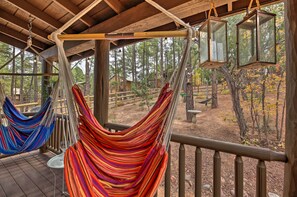A hammock under a wooden deck with a view of a forest. - Trail Access: Pet-Friendly Cabin in Show Low! (Show Low)