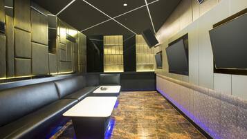 Relax in a stylish lounge area with a sleek sofa, matching bench, and patterned tile floor.
